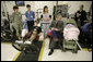 President George W. Bush peeks in at 2-month-old Hailey Yvonne Gardner while visiting with her parents U.S. Army Sgt. David Glenn Gardner and Beverly Yvonne Gardner, both of Lindon, Utah, Friday, March 30, 2007, during a visit to Walter Reed Army Medical Center in Washington, D.C. White House photo by Eric Draper