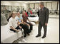 President George W. Bush spends time with Minnesota National Guard Sgt. John Matthew Kriesel of Cottage Grove, Minn., Friday, March 30, 2007, during a visit to Walter Reed Army Medical Center in Washington, D.C. Sitting with Sgt. Kriesel is his wife, Katharine Marie Kriesel, and father John Joseph Kriesel. White House photo by Eric Draper