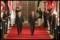 President George W. Bush walks with Dr. Ibrahim Jaafari, Prime Minister of Iraq, toward the East Room Friday, June 24, 2005, to meet the media. White House photo by Paul Morse