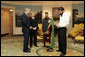 President George W. Bush greets 11-year-old Vasila Hossaini in the Diplomatic Reception Room of the White House Thursday, June 2, 2005. The Afghan youth recently underwent surgery to correct a congenital heart defect that allows un-oxygenated blood to circulate through her body. Project Kids Worldwide, a non-profit organization, that helps provide surgery and other medical care to impoverished children suffering from heart defects, helped to arrange the meeting with the President. With her is her father, Arman, in dark jacket; filmmaker Stacia Teele, who is documenting Vasila's illness and trip, and Hameed Said, their interpreter. White House photo by Paul Morse