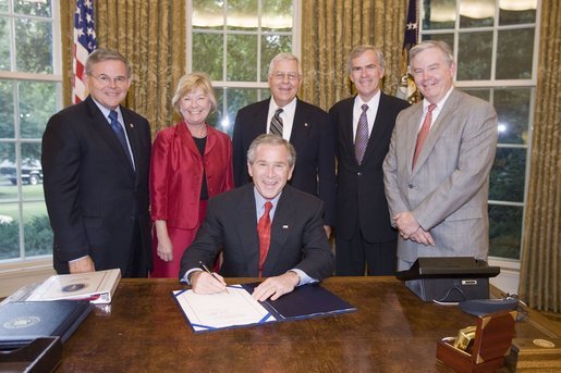 President George W. Bush is surrounded by members of Congress as he signs H.R. 1812, the Patient Navigator Outreach and Chronic Disease Prevention Act of 2005, in the Oval Office Wednesday, June 29, 2005. With him are, from left: Congressman Bob Menendez, D-N.J.; Congresswoman Deborah Pryce, R-Ohio; Senator Mike Enzi, R-Wyo., Senator Jeff Bingaman, D-N.M., and Congressman Joe Barton, R-Texas. White House photo by Paul Morse