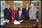 President George W. Bush is surrounded by members of Congress as he signs H.R. 1812, the Patient Navigator Outreach and Chronic Disease Prevention Act of 2005, in the Oval Office Wednesday, June 29, 2005. With him are, from left: Congressman Bob Menendez, D-N.J.; Congresswoman Deborah Pryce, R-Ohio; Senator Mike Enzi, R-Wyo., Senator Jeff Bingaman, D-N.M., and Congressman Joe Barton, R-Texas. White House photo by Paul Morse