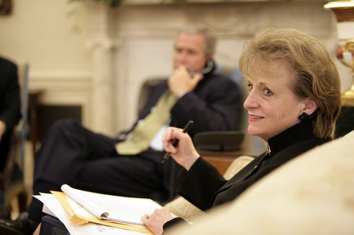 White House Counsel Harriet Miers sits in the Oval Office July 1, 2005, as President George W. Bush speaks on the phone in the background. White House photo by Eric Draper