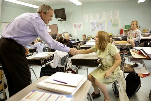 President George W. Bush introduces himself to a student Tuesday, Oct. 11, 2005 at Delisle Elementary School in Pass Christian, Miss., the school reopened Tuesday for the first time since Hurricane Katrina devastated the Gulf Coast region. White House photo by Eric Draper