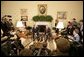 President George W. Bush talks to reporters during a visit with Italian Prime Minister Silvio Berlusconi in the Oval Office at the White House, Monday, Oct. 31, 2005 in Washington. White House photo by Eric Draper