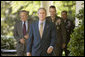 President George W. Bush walks to the Rose Garden Wednesday, Oct. 5, 2005, followed by Secretary of Defense Donald Rumsfeld, General Peter Pace, Chairman of the Joint Chiefs of Staff, and Gen. David Petraeus, former Commander of the Multinational Security and Transition Team in Iraq. White House photo by Paul Morse