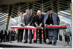 President George W. Bush and Afghanistan President Hamid Karzai, right, cut the ceremonial ribbon, Wednesday, March 1, 2006, to dedicate the new U.S. Embassy Building in Kabul, Afghanistan. President Bush is joined by Mrs. Laura Bush; U.S. Secretary of State Condoleezza Rice and U.S. Ambassador to Afghanistan Ronald E. Neumann.  White House photo by Eric Draper