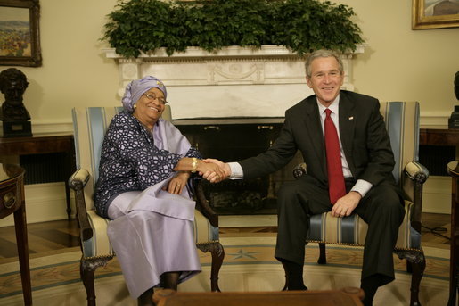 President George W. Bush welcomes Liberia's President Ellen Johnson Sirleaf to the Oval Office at the White House, Tuesday, March 21, 2006. President Sirleaf is the first woman elected President to any country on the continent of Africa. White House photo by Eric Draper