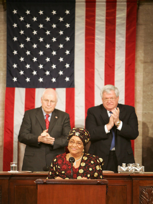 Vice President Dick Cheney and House Speaker J. Dennis Hastert applaud Liberian President Ellen Johnson-Sirleaf during an address to a Joint Meeting of Congress, Wednesday, March 15, 2006. The President’s speech marked the beginning of a multi-day trip to Washington that will include meetings with US officials in an effort to garner support as she leads her country in economic reconstruction and reform. White House photo by David Bohrer