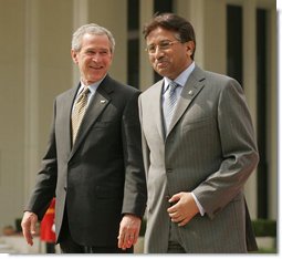 President George W. Bush and Pakistan President Pervez Musharraf walk together to their joint news conference at Aiwan-e-Sadr in Islamabad, Pakistan, Saturday, March 4, 2006. White House photo by Shealah Craighead