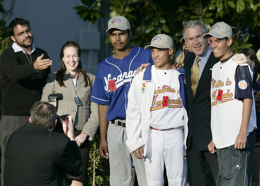 President George W. Bush poses for photographs with South American baseball players Tuesday, March 14, 2006, on the South Lawn of the White House. The players were guests at the arrival of Marine One after the President's trip to New York. The group is here on a State Department-funded International Sports Exchange centered around a shared passion of baseball and the inaugural World Baseball Classic. The players, from left, are: Geovanny Toval Monterrey, 17, from Nicaragua; Ronald Torreyes Solorzano, 14, from Venezuela; Bryan Guillen, 16, (in back) from Nicaragua, and Argerd Liendo Boada, 16, from Venezuela. White House photo by Eric Draper