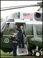 President George W. Bush waves from the steps of Marine One on the South Lawn of the White House, Wednesday, March 29, 2006, as he departs for a three-day summit with the leaders of Mexico and Canada in Cancun, Mexico. White House photo by Shealah Craighead