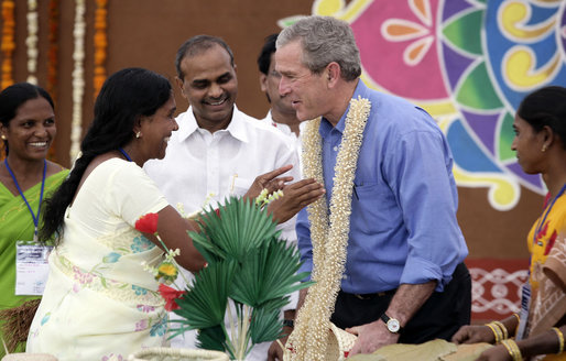 President George W. Bush is presented with a flowered neck garland upon his arrival Friday, March 3, 2006, to Acharya N.G. Ranga Agriculture University in Hyderabad, India. White House photo by Eric Draper