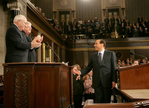 Italian Prime Minister Silvio Berlusconi smiles at Vice President Dick Cheney and House Speaker J. Dennis Hastert, as he gestures in response to a warm welcome given by members of a joint session of Congress, Wednesday, March 1, 2006. White House photo by David Bohrer