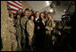 President George W. Bush poses for photos with U.S. and Coalition troops Wednesday, March 1, 2006, during a stopover at Bagram Air Base in Afghanistan, prior to his visit to India and Pakistan. White House photo by Eric Draper