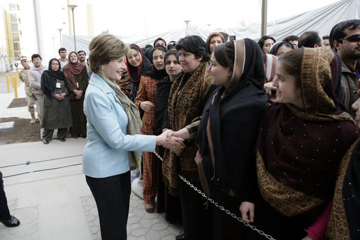 Mrs. Laura Bush greets a welcoming delegation of women, Wednesday, March 1, 2006, at the dedication of the new U.S. Embassy Building in Kabul, Afghanistan. White House photo by Eric Draper