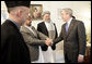 President George W. Bush meets members of President Hamid Karzai's government upon his arrival for a working lunch at the Presidential Palace in Kabul, Afghanistan Wednesday, March 1, 2006. White House photo by Eric Draper
