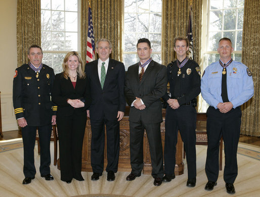 President George W. Bush meets Thursday, March 16, 2006 in the Oval Office of the White House with recipients of the Public Safety Officer Medals of Valor. From left to right are, Gene F. Large Jr., Fire Battalion Chief in Fort Walton Beach, Fla.; Marissa Hurst, wife of slain Officer Bryan S. Hurst of Columbus, Ohio; Peter Alfred Koe, Police Officer of Indianapolis, Ind.; Timothy Greene, Police Officer from Rock Hill, S.C.; and Firefighter Edward Frederic Henry of Charleston, S.C. White House photo by Paul Morse