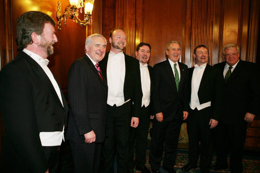 President George W. Bush is joined by House Speaker Dennis Hastert (R-Ill.), right, and Prime Minister Bertie Ahern of Ireland, as they stand with the McCrohan Tenors after the trio's performance Thursday, March 16, 2006, during a St. Patrick's Day Luncheon at the U.S. Capitol. White House photo by Kimberlee Hewitt