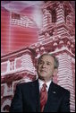 President George W. Bush stands before a backdrop of Ellis Island, Monday, March 27, 2006, at the Naturalization Ceremony for new U.S. citizens at the Daughters of the American Revolution Administration Building in Washington. President Bush welcomed the new U.S. citizens, telling them that each generation of immigrants brings a renewal to our national character and adds vitality to our culture. White House photo by Eric Draper