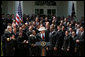 President George W. Bush joins the United States Naval Academy Football Team Monday, April 14, 2008, following the presentation of the Commander-in-Chief's Trophy to the The Naval Academy Midshipmen in the Rose Garden of the White House. White House photo by Joyce N. Boghosian