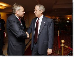 President George W. Bush greets NATO Secretary General Jaap de Hoop Scheffer Wednesday, April 2, 2008, at the JW Marriott Bucharest Grand Hotel in Bucharest, site of the 2008 NATO Summit. White House photo by Eric Draper