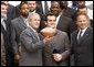 Louisiana State University Tigers' running back Jacob Hester stands next to President George W. Bush after presenting him with a football during a visit to the White House Monday, April 7, 2008, by the 2007 NCAA Football Champions. White House photo by Eric Draper