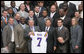 President George W. Bush holds up an LSU Tigers' jersey presented to him Monday, April 7, 2008 by the 2007 NCAA Football Champions during their visit to the White House. White House photo by Chris Greenberg