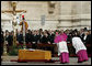 Archbishop Piero Marini, left, chief liturgist to Pope John Paul II, bows to his casket during the Pope's funeral Friday, April 8, 2005, in St. Peter's Square.White House photo by Eric Draper