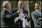 President George W. Bush jokes with New England Patriots owner Robert Kraft during a ceremony honoring the 2005 Super Bowl Champions in the Rose Garden April 13, 2005.White House photo by Eric Draper