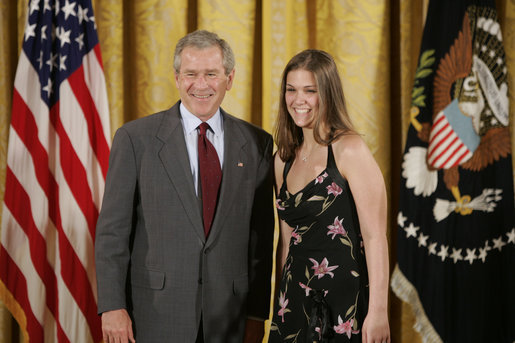 President George W. Bush congratulates Heather Renee Dornan, 18, of Del City High School Water Watch Program Student Volunteers of Del City, Okla., on receiving the President’s Environmental Youth Award in the East Room of the White House April 21, 2005. White House photo by Paul Morse