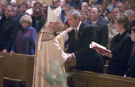 Cardinal Theodore McCarrick greets President George W. Bush and Mrs. Laura Bush after mass at the Cathedral of Saint Matthew the Apostle in Washington, DC on Saturday, April 2, 2005 in remembrance of Pope John Paul II. White House photo by Paul Morse