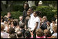 From left: Wendall Jefferson, Ta-Sha Watkins, Marco Jeter and Brandy Beaman receive applause as they stand after being acknowledged by their math teacher, Jason Kamras, the 2005 National Teacher of the Year, during ceremonies at the Rose Garden. White House photo by Krisanne Johnson