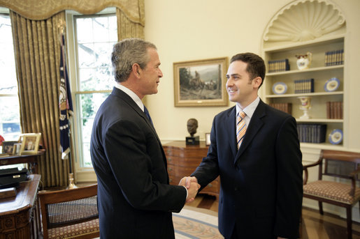 President George W. Bush welcomes Jason Kamras, the 2005 National Teacher of the Year, to the Oval Office during ceremonies Wednesday, April 20, 2005, at the White House. Mr. Kamras, a 1996 Princeton graduate, teaches seventh and eighth grade math at John Philip Sousa Middle School in Washington, D.C. "Teaching is a commitment to equity and opportunity for all children," says Mr. Kamras, who took time away from teaching in 1999-2000 to earn his Master's degree at Harvard. "It is a promise of a better future for those who have been left behind." White House photo by Eric Draper