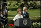 President George W. Bush looks on as he's introduced by First Lady Laura Bush Wednesday, April 20, 2005, to honor the 2005 National Teacher of the Year during ceremonies in the Rose Garden. Jason Kamras, a math teacher of eight years at John Philip Sousa Middle School in Washington, D.C., received the honors. White House photo by Krisanne Johnson