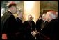 President George W. Bush greets U.S.-based Roman Catholic Cardinals during a reception Thursday, April 7, 2005, in Rome at Villa Taverna, the residence of the Mel Sembler, U.S. Ambassador to Italy. From left are: Roger Cardinal Mahony, archbishop of Los Angeles; President Bush; Francis Cardinal George, archbishop of Chicago; Justin Cardinal Rigali, archbishop of Philadelphia, and William Cardinal Keeler, archbishop of Baltimore. White House photo by Eric Draper