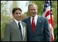 President George W. Bush congratulates Benjamin Banwart, 18, of Shakopee, Minn., on receiving the President’s Environmental Youth Award in the East Garden April 22, 2004. White House photo by Susan Sterner.