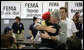 President George W. Bush hugs an unidentified woman Thursday, Oct. 25, 2007, at a FEMA emergency center in Rancho Bernardo, California. The President visited the Southern California area hard hit by recent wildfires, consoling those who lost their homes and commending those whose efforts saved others. White House photo by Eric Draper