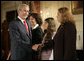 President George W. Bush greets his guests Marlenis Gonzalez, right, and her daughter Melissa, center, Wednesday, October 24, 2007, after his remarks on Cuba policy at the State Department in Washington, D.C. Melissa's father, Jorge Luis Gonzalez Tanquero is currently being held in a Cuban prison after being arrested for crimes against the regime. White House photo by Eric Draper