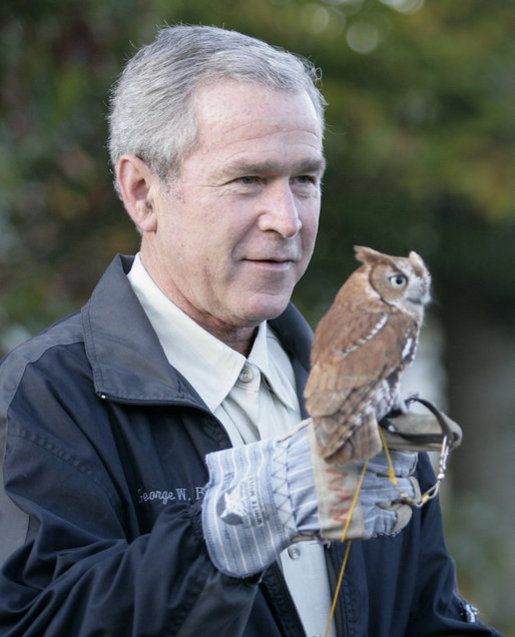 President George W. Bush holds a screech owl Saturday, Oct. 20, 2007 at the Patuxent Research Refuge in Laurel, Md., where President Bush discussed steps his Administration is creating for a series of cooperative conservation steps to preserve and restore critical stopover habitat for migratory birds in the United States. White House photo by Eric Draper