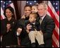 President George W. Bush is seen Thursday, Dec. 1. 2005 in the Eisenhower Executuive Office Building in Washington, as he poses for photos with U.S. Rep. Jesse Jackson Jr. and his children, Jesse Jackson III and Jessica, following the signing of H.R. 4145, to Direct the Joint Committee on the Library to Obtain a Statue of Rosa Parks, which will be placed in the US Capitol's National Statuary Hall. U.S. Secretary of State Condoleezza Rice is seen at left. White House photo by Paul Morse