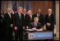 President George W. Bush signs H.R. 4440, the Gulf Opportunity Zone Act of 2005, Wednesday Dec. 21, 2005, as administration officials and legislative members join him for the signing ceremony held in the Dwight D. Eisenhower Executive Office Building in Washington. White House photo by Paul Morse