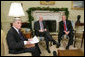 President George W. Bush meets with U.S. Senator John McCain, R-Ariz., and U.S. Senator John Warner, R-Va., Thursday, Dec. 15, 2005 in the Oval Office, to discuss the U.S. position on the interrogation of prisoners. White House photo by Paul Morse