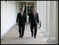 President George W. Bush walks along the Colonnade with Judge John G. Roberts, the President's nominee to the Supreme Court, during an early morning visit Wednesday, July 20, 2005, to the White House. White House photo by Eric Draper