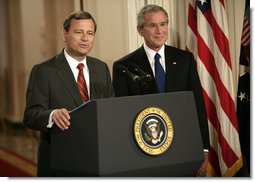 President George W. Bush looks on as his Supreme Court Justice Nominee John Roberts delivers remarks on the State Floor of the White House, Tuesday evening, July 19, 2005. White House photo by Eric Draper