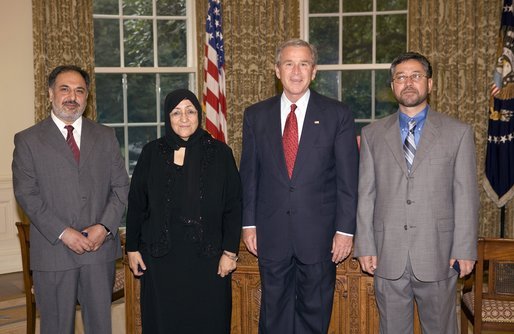 President George W. Bush stands with the recipients of the 2005 Democracy Award of the National Endowment for Democracy Wednesday, July 13, 2005, in the Oval Office. The three democracy activists from Afghanistan are leaders of civil society organizations and have distinguished themselves in educating average citizens and local leaders about the basic values and principles of democracy. With the President, from left are: Mohammed Nasib, Sakeena Yacoobi and Sarwar Hussaini. White House photo by Eric Draper
