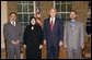 President George W. Bush stands with the recipients of the 2005 Democracy Award of the National Endowment for Democracy Wednesday, July 13, 2005, in the Oval Office. The three democracy activists from Afghanistan are leaders of civil society organizations and have distinguished themselves in educating average citizens and local leaders about the basic values and principles of democracy. With the President, from left are: Mohammed Nasib, Sakeena Yacoobi and Sarwar Hussaini. White House photo by Eric Draper