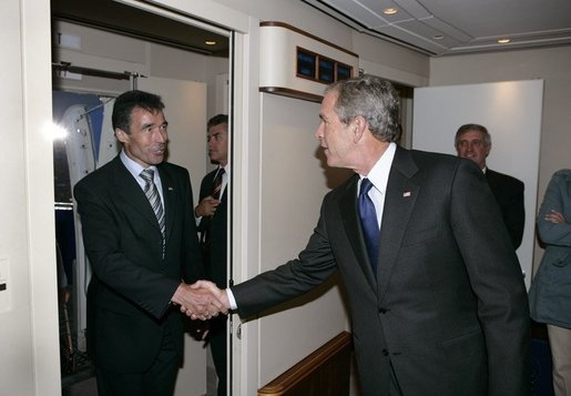 President George W. Bush welcomes Prime Minister Anders Fogh Rasmussen aboard Air Force One after arriving in Kastrup, Denmark, Tuesday, July 5, 2005. White House photo by Eric Draper