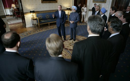 President George W. Bush stands with Prime Minister Manmohan Singh of India, in the Blue Room of the White House Monday, July 18, 2005, as they visit with U.S.-India CEO Forum members. White House photo by Eric Draper
