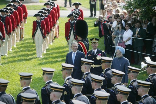 President George W. Bush reviews an honor guard with India's Prime Minister Dr. Manmohan Singh, Monday, July 18, 2005, on the South Lawn of the White House, during Singh's official arrival ceremony. White House photo by Lynden Steele